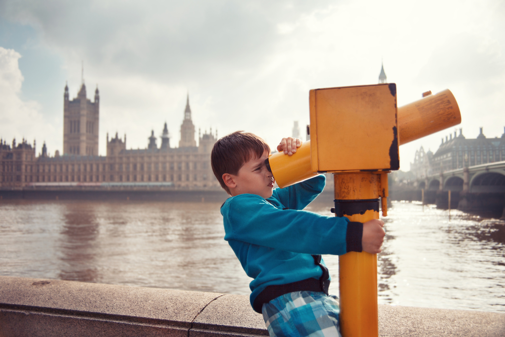 Child looking through a telescope