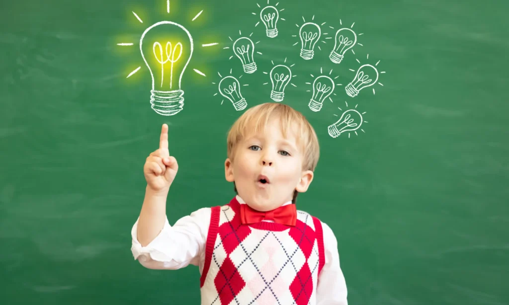 Child having and idea with black board in the background