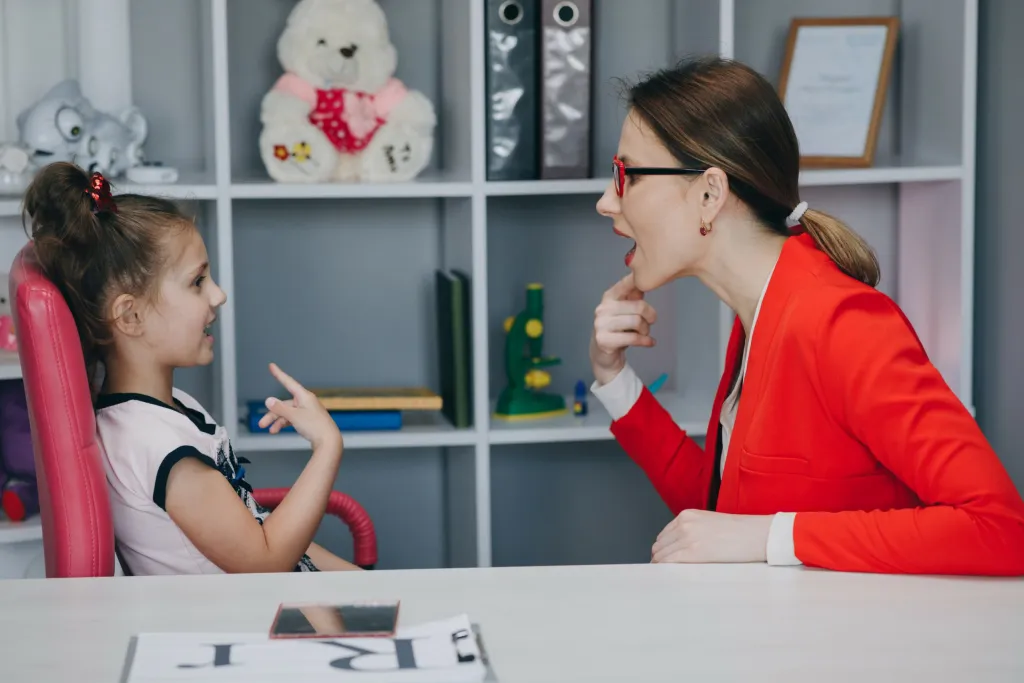 Child learning to speak with therapist
