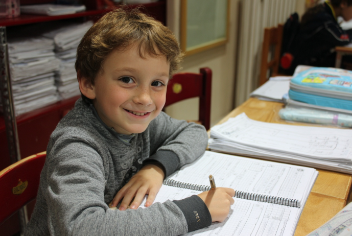 Un niño estudiando los tiempos verbales en inglés